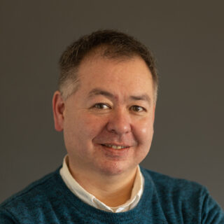 Gordon Cheung, Scotland Network Manager, a Chinese male with brown-grey hair and a blue jumper