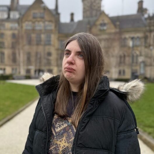 Close up photo of CAP worker, Amy, stood in Bradford centre, looking away from the camera