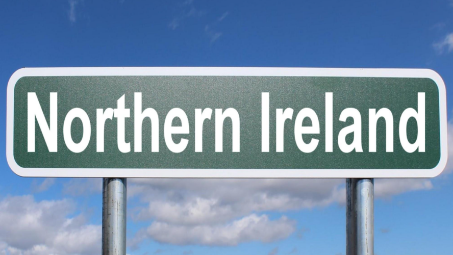 Green road sign with white text saying 'Northern Ireland'