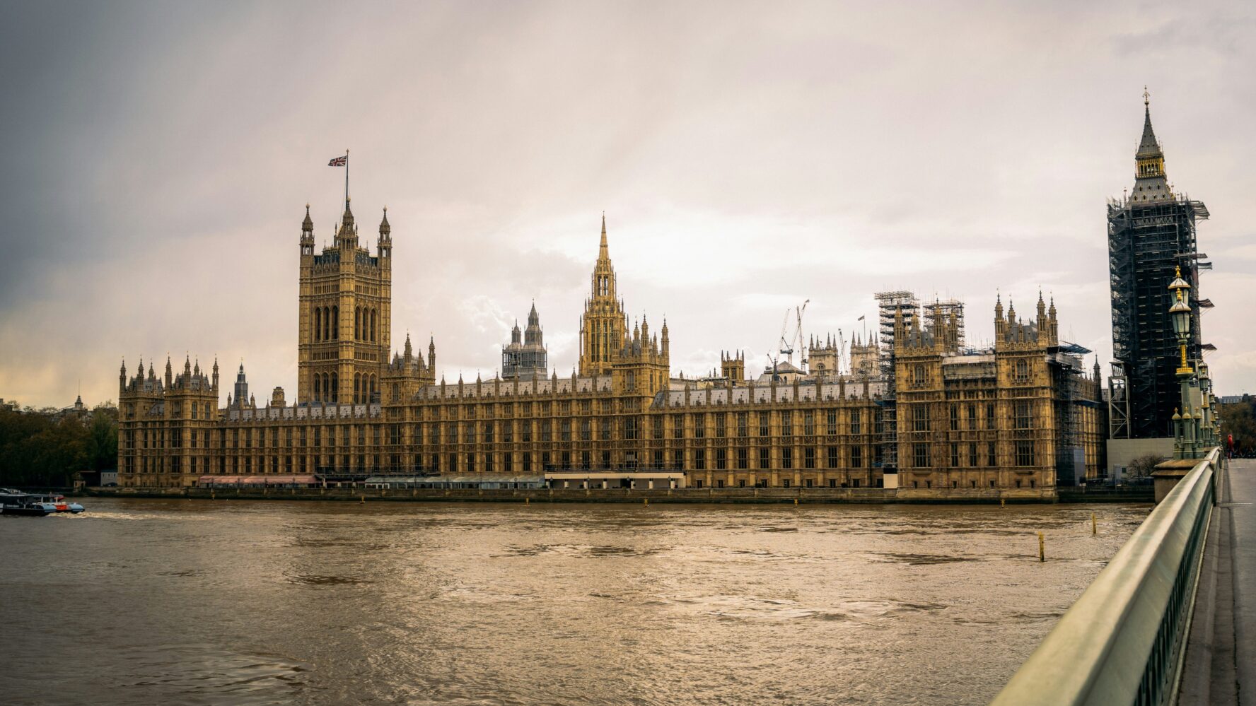 A wide shot of Westminster, London with the sun shining behind it