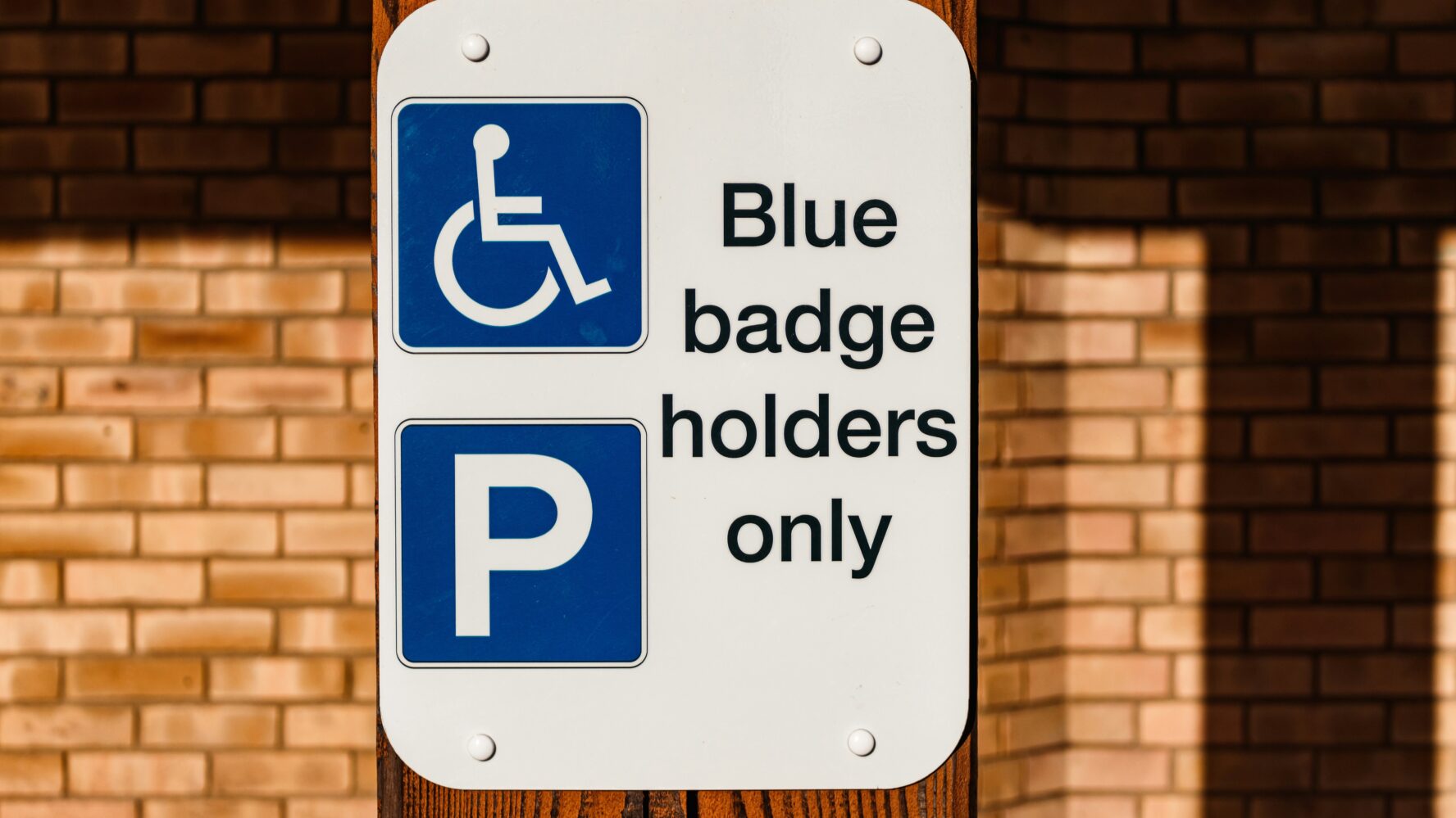 Disability blue badge parking sign on street