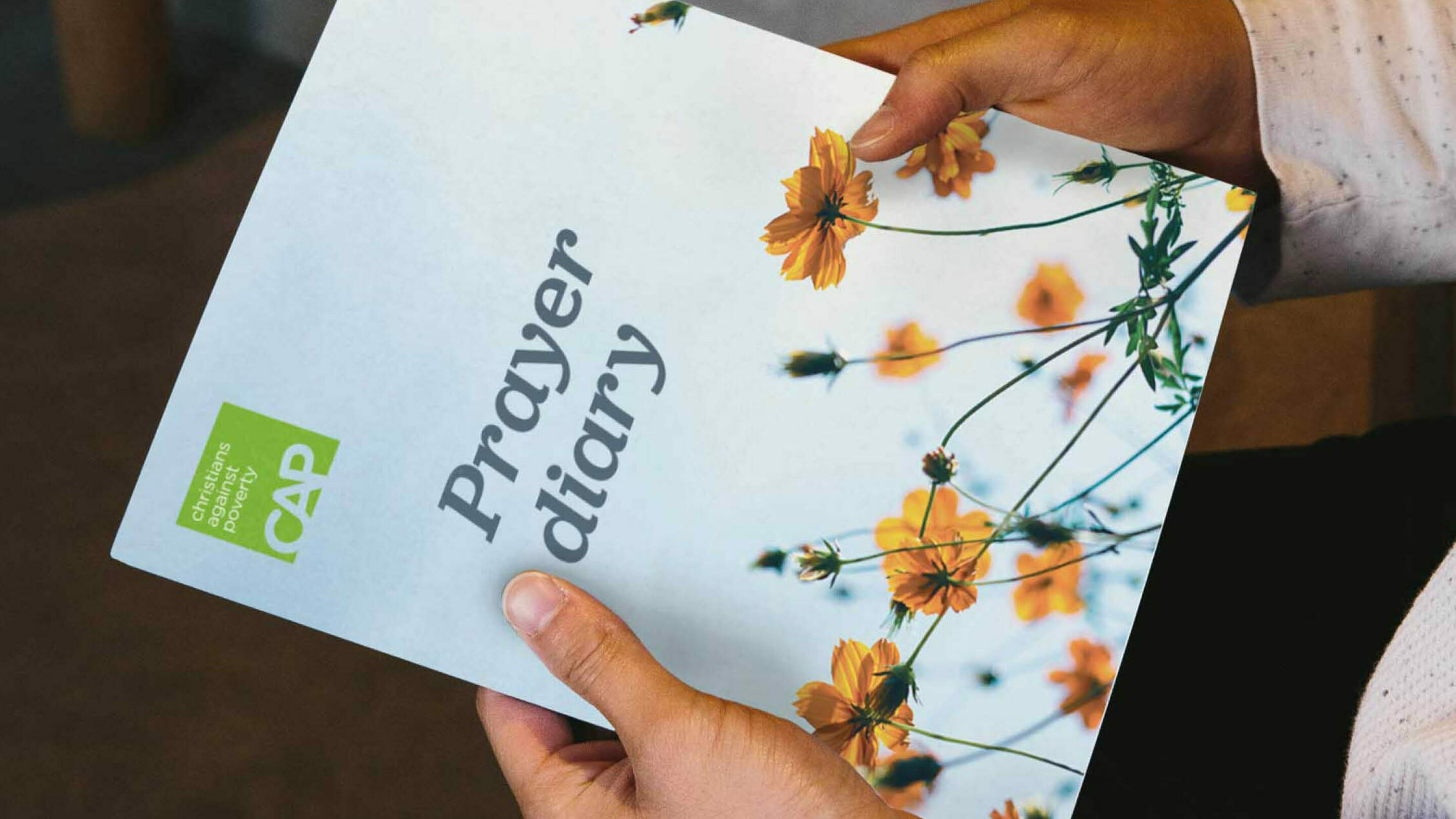 Woman holding CAP prayer diary