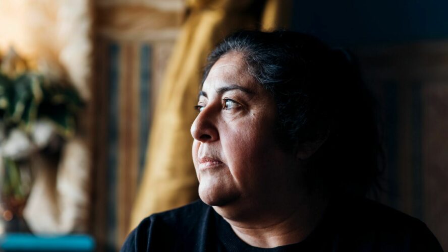 Woman looking pensive across her shoulder.