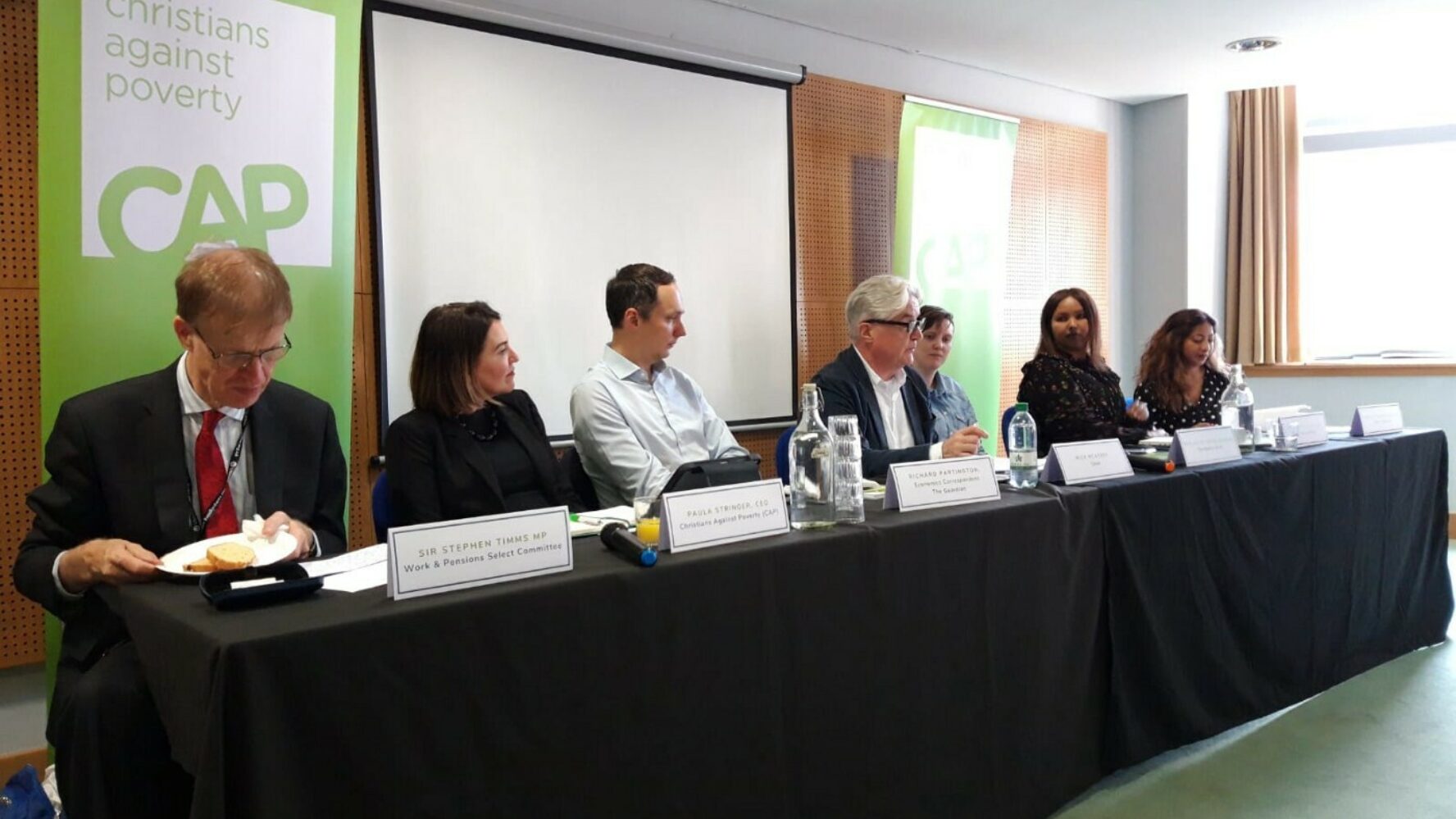 Panel members of the CAP Labour Party conference fringe event sit along a table facing the audience.