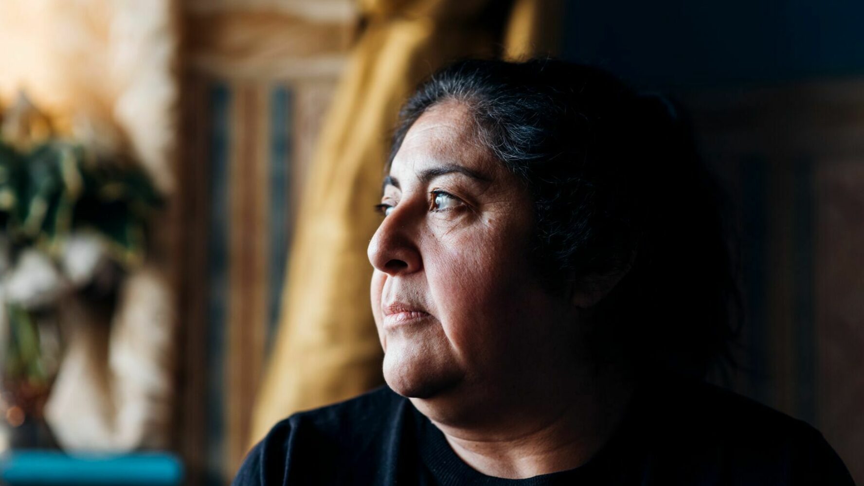 Woman looking pensive across her shoulder.