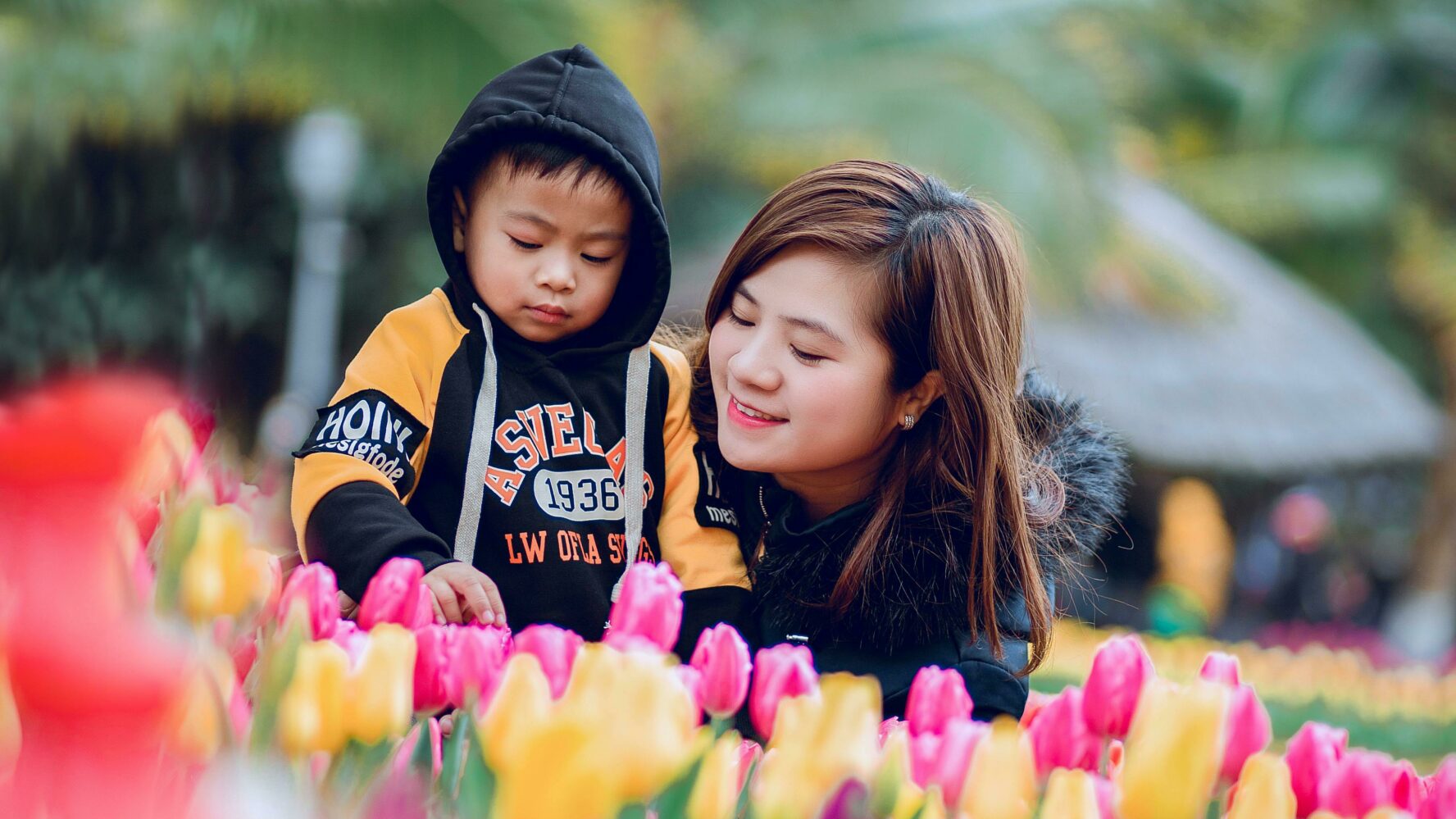 A mum and her son looking at tulips