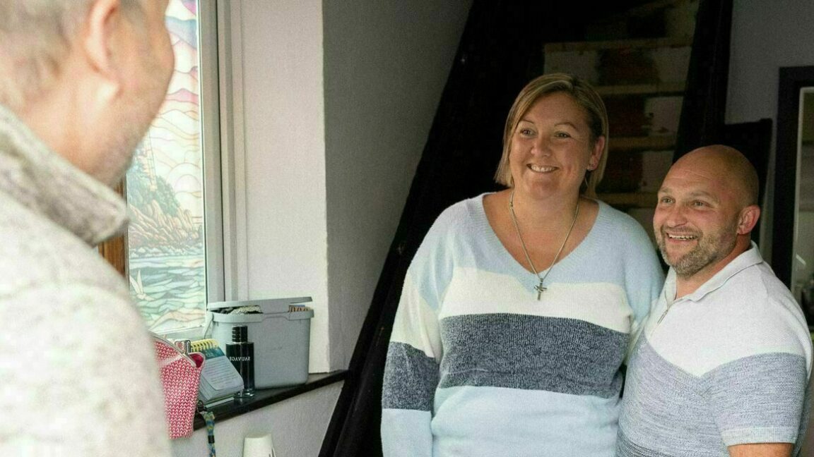 Two CAP clients opening the door to their debt coach