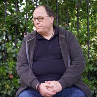 CAP client, Simon, sat on a park bench