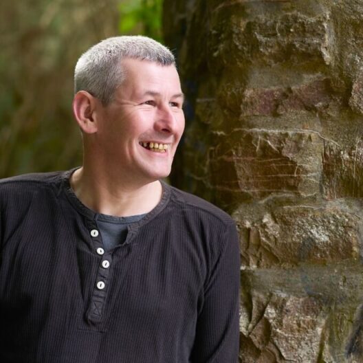 CAP client, Peter, stood outside, smiling and looking away from the camera