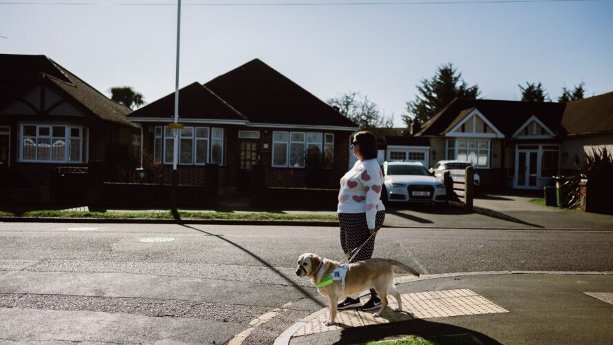 CAP client, Angela, crossing the street with her guide dog