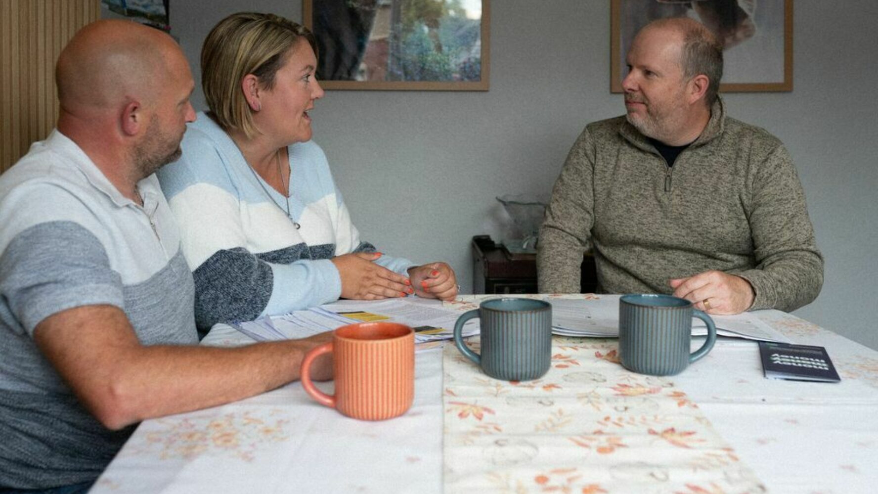 Two CAP clients sat at their dining table with their debt coach
